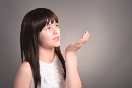 Beautiful cute girl with dark hair posingの写真素材