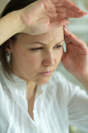 Portrait of a young woman with headacheの写真素材
