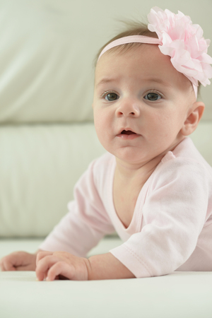 Cute charming girl with a flower on her headの写真素材
