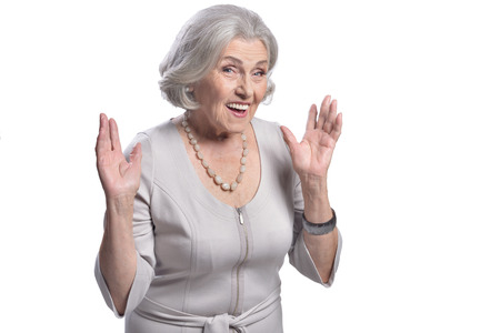 Portrait of surprised senior woman posing on white background