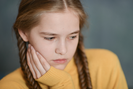 Close-up portrait of sad sick girl suffering from illnessの写真素材