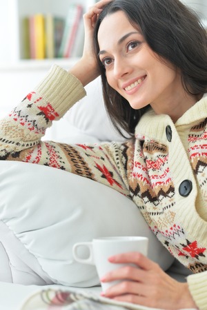 Beautiful woman with a cup of teaの写真素材