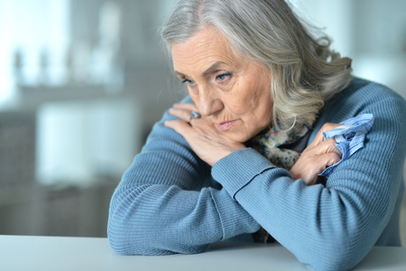 Close up portrait of sick senior womanの写真素材