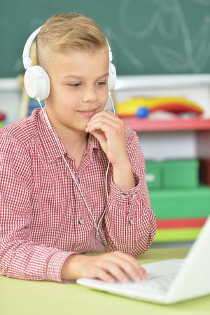 boy with headphones using laptopの写真素材