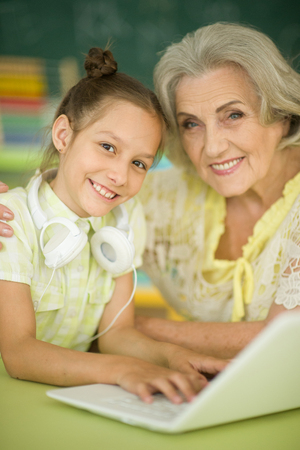 grandmother and daughter using laptopの写真素材
