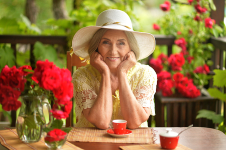happy aged woman  drinking coffeeの写真素材