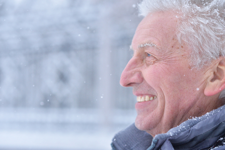 Portrait of smiling senior man standing outdoorsの写真素材