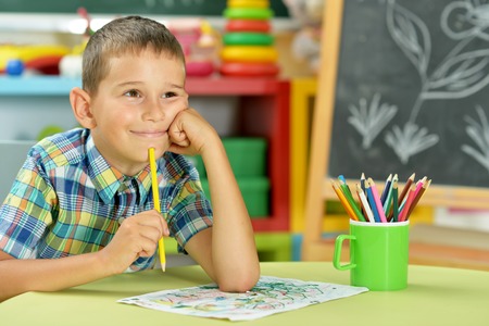 little boy drawing with pencilの写真素材