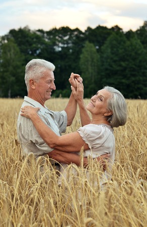Senior couple resting at  summer fieldの写真素材