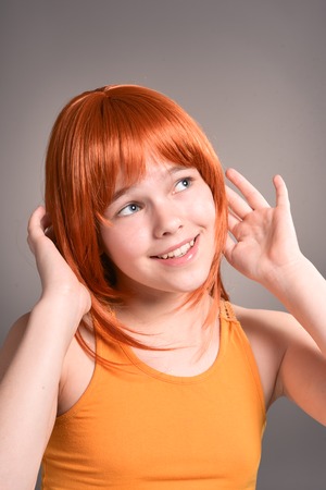 Portrait of beautiful young girl posing on backgroundの写真素材