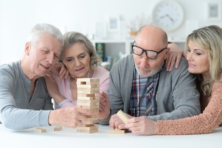 Portrait of senior couples playing with wooden blocksの写真素材