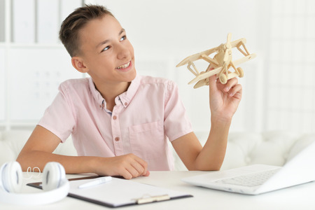 boy with model of plane and handsawの写真素材