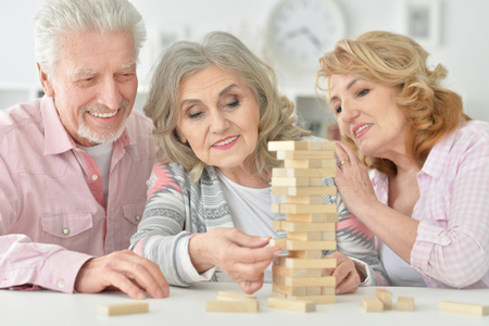 senior people playing with wooden blocksの写真素材