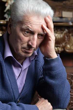 Portrait of sad senior man posingの写真素材