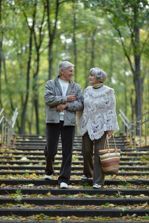 beautiful caucasian senior couple walking  in parkの写真素材