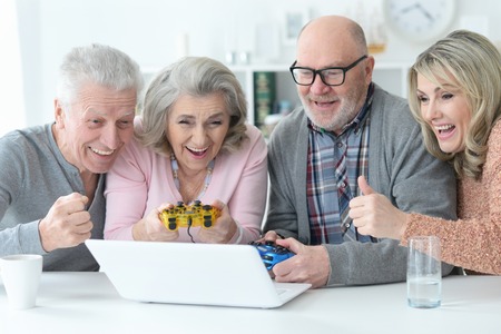senior couples playing computer gameの写真素材