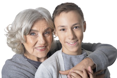 Portrait of grandmother and grandson having fun on white backgroundの写真素材