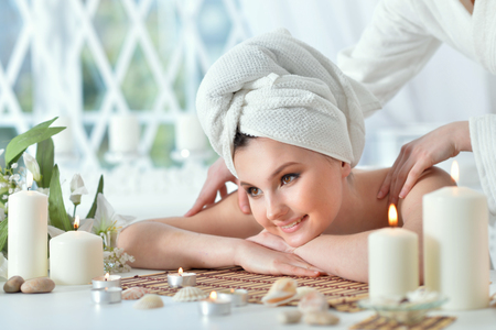 Portrait of girl lying down on a massage bedの写真素材