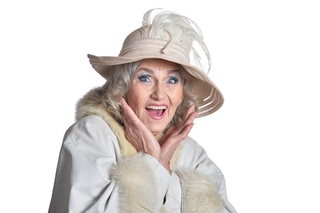 Smiling gorgeous mature woman in white coat isolated on white background
