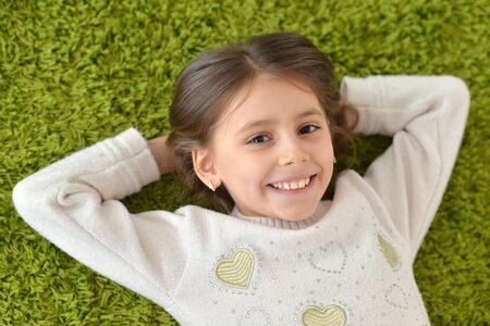 Close-up portrait of little girl posing at homeの写真素材