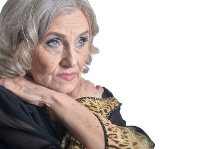 Sad senior woman posing against white backgroundの写真素材