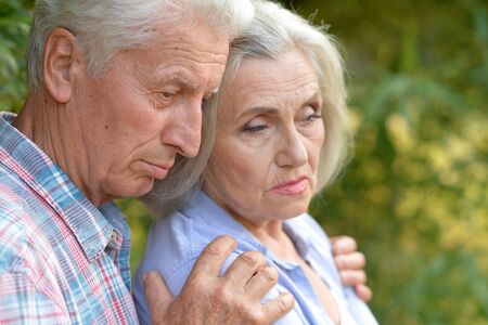 Portrait of unhappy senior couple in the parkの写真素材