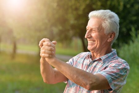 Portrait of smiling senior man in park