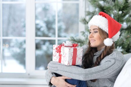 Portrait of smiling woman with Christmas giftの写真素材