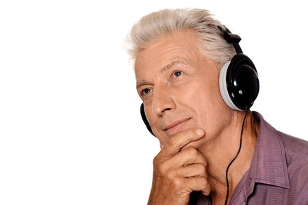 Close up portrait of senior man listen music in headphonesの写真素材