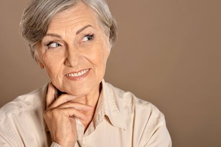 Close up portrait of beautiful smiling senior woman posingの写真素材
