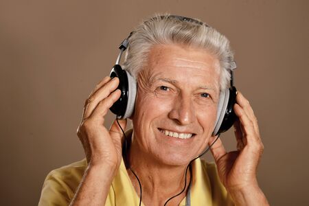 Portrait of senior man listening to music