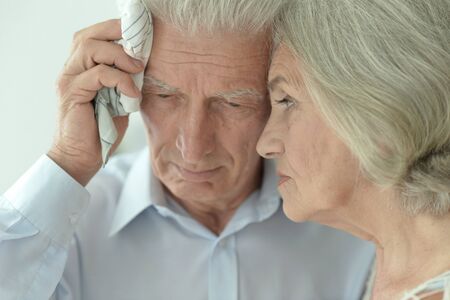 Close up portrait of sick elderly woman and man at homeの写真素材