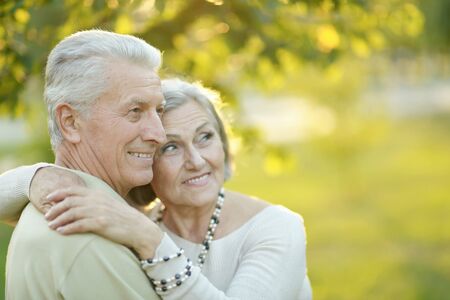 Portrait of smiling senior couple in autumn park