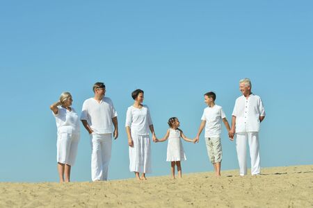 Portrait of happy family together on sand beachの写真素材