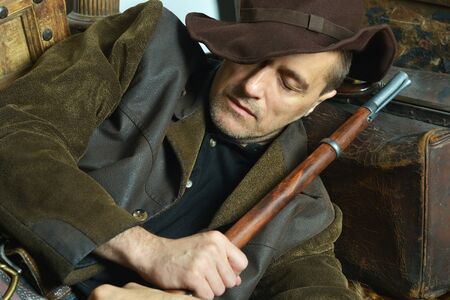 Bandit with gun in the wild west sleeping
