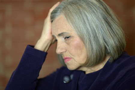 Close up portrait of sad ill senior woman