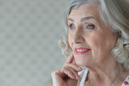 Portrait of beautiful happy senior woman at homeの写真素材