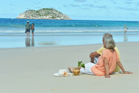Portrait of elderly couple at tropical beachの写真素材