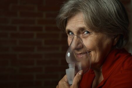 Portrait of elderly woman with flu inhalationの写真素材