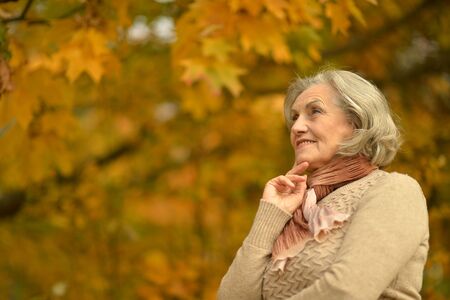 Portrait of senior smiling woman in park