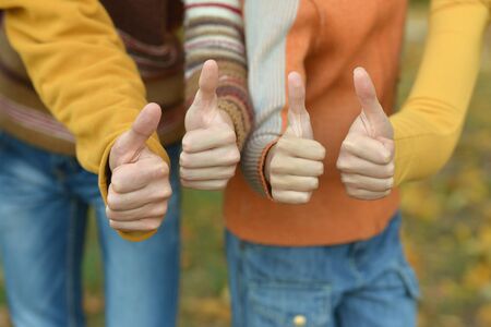 Portrait of cropped image, family showing thumbs upの写真素材