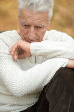 Portrait of senior man thinking in parkの写真素材