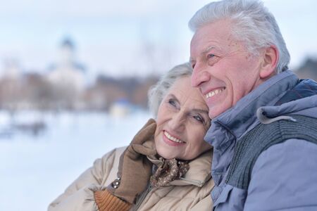 Close up portrait of happy senior couple hugging