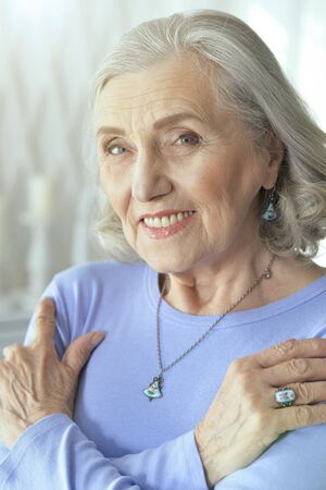 Portrait of beautiful senior woman posing at home