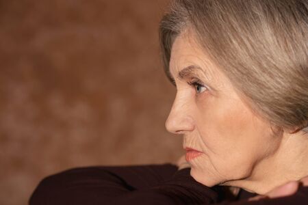 Portrait of sad senior woman at homeの写真素材