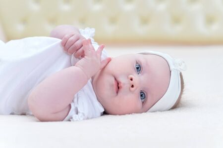 Cute little baby girl lying on her back