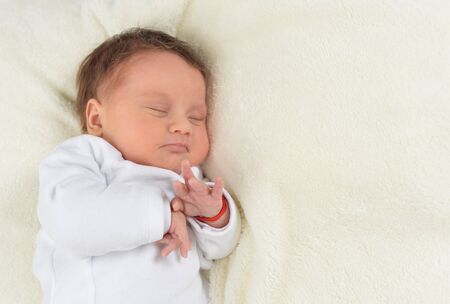 Cute little baby boy on bed sleeping
