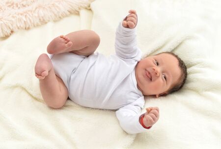 Portrait of cute little baby boy on bed