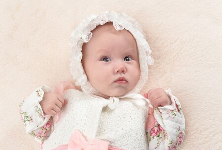 Portrait of cute little baby girl on bed