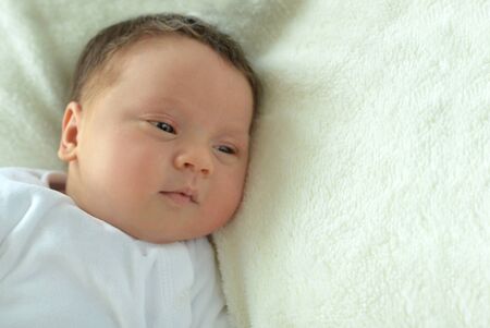 Portrait of cute little baby boy on bed
